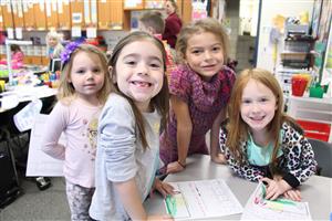 Children in classroom smiling 
